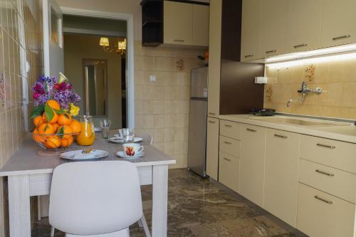 a kitchen with a table with a bowl of fruit at katia's home nafplio in Nafplio