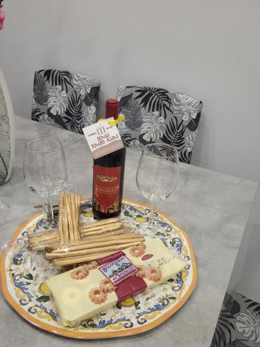 a plate of cheese and crackers on a table with glasses at Domus Pompeii Ruins in Pompei