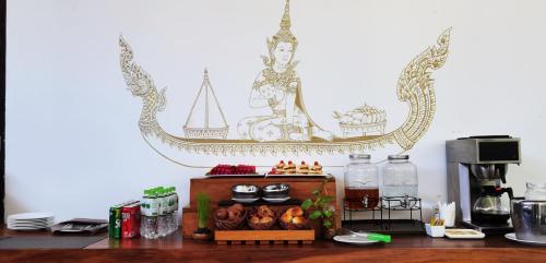 a kitchen with a counter with a coffee maker and food at Sarina Boutique Hotel in Phnom Penh
