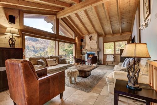a living room with a couch and a fireplace at Chalet le Cerf in La Tzoumaz