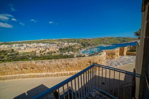 a view of a city from a balcony of a building at Harbour Views Duplex Maisonette with Jacuzzi Hot tub in Mġarr