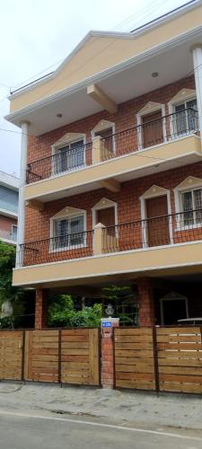 a brick building with a wooden fence in front of it at Catalyst Suites,Domlur in Bangalore