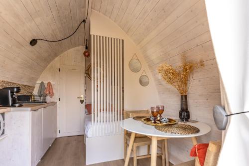 a kitchen and dining room with a table and chairs at Domaine des Vignères in Saint-Maurice-de-Tavernole
