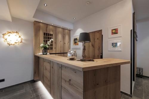 a kitchen with a wooden island with a lamp on it at Hotel Neuwirt in Mieming