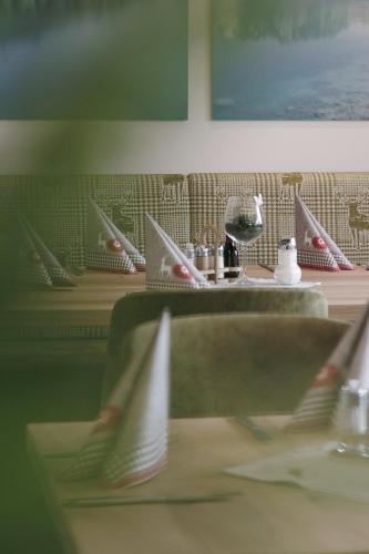 a row of tables with plates and wine glasses at Hotel Neuwirt in Mieming