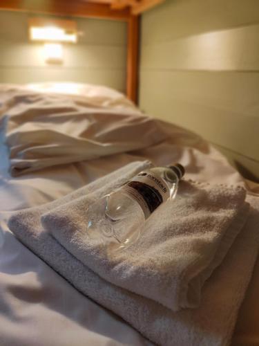 a bottle sitting on top of a bed at Tonstadli in Tonstad