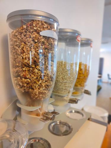 a group of jars filled with nuts on a counter at Tonstadli in Tonstad