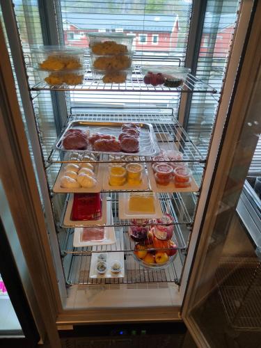a refrigerator filled with lots of different types of donuts at Tonstadli in Tonstad