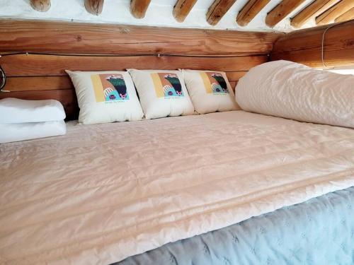 a bed in a room with pillows on it at Hyanggyo-gil, Seonwooga in Jeonju