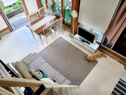 a living room with a couch and a television and a table at Hyanggyo-gil, Seonwooga in Jeonju