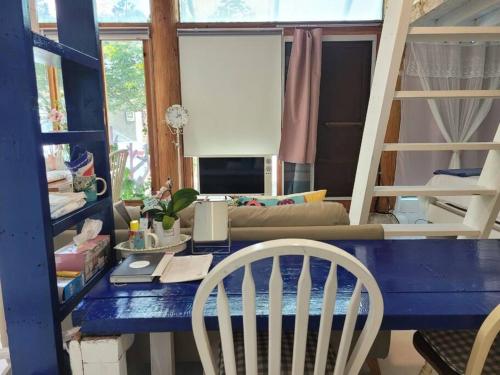 a room with a blue desk and a couch at Hyanggyo-gil, Seonwooga in Jeonju