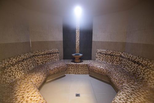 a room with two chairs and a potasteryasteryasteryasteryasteryasteryasteryastery at Ruskovets Thermal SPA & Ski Resort in Bansko