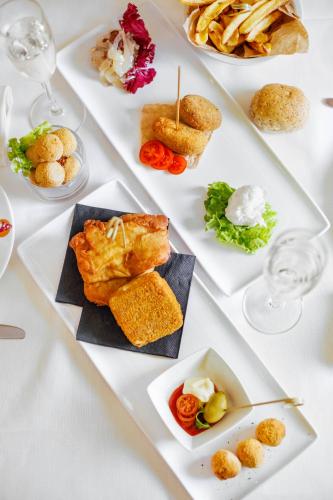 a white table with plates of food on it at Hotel Colombina in Venice