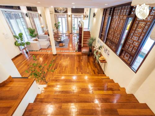a staircase in a home with wooden floors and windows at 6BR San He Yuan RIAD Private Pool Villa KLCC View by Verano in Kuala Lumpur