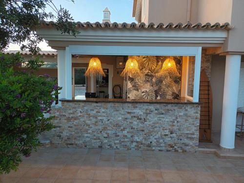 a shop window with lights in a brick wall at VILLA L'ESTAQUE in Armação de Pêra