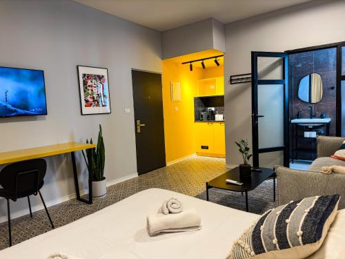 a living room with a bed and a kitchen at Levinski Market Hotel in Tel Aviv