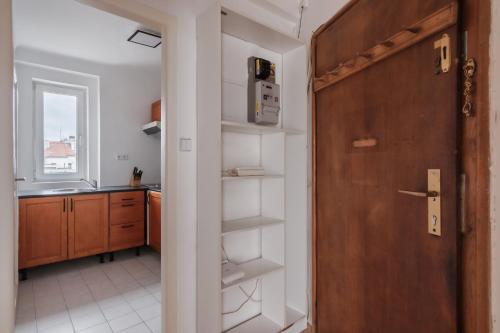 Zimmer mit einer Tür und einer Küche mit einer Theke in der Unterkunft Sunny Condo in Holešovice by Prague Days in Prag