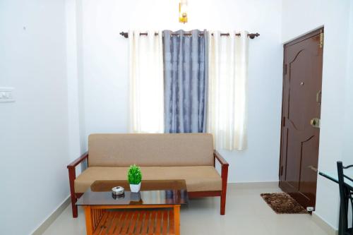 a living room with a couch and a table at The Coorg Heaven in Madikeri