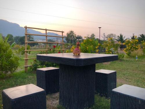 a toy figurine sitting on top of a table at คูณ-เนื่อง ฟาร์ม สเตย์ หัวหิน Koon & Nueang Farm Stay Hua Hin in Ban Bo Fai