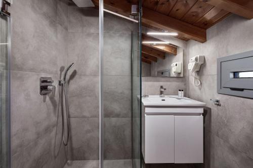 a bathroom with a shower and a sink at Quattro Suites in Monemvasia