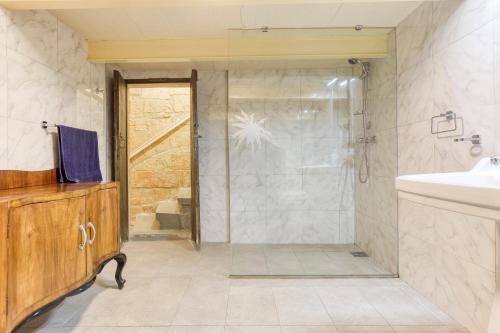 a bathroom with a shower and a sink at VLT214- Valletta 2 Bedroom Townhouse in Valletta