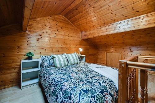 a bedroom with a bed in a wooden room at Poppy's Pad - Winchester Road in Liverpool