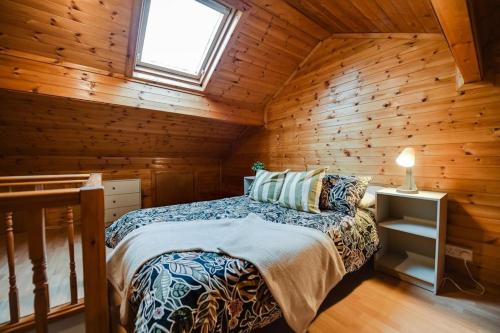 a bedroom with a bed in a wooden cabin at Poppy's Pad - Winchester Road in Liverpool