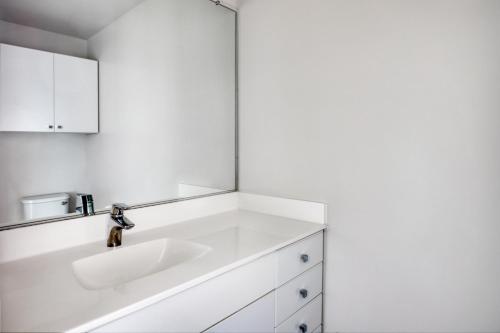 a white bathroom with a sink and a mirror at ChinatownTheater District 2br w wd gym nr T BOS-376A in Boston