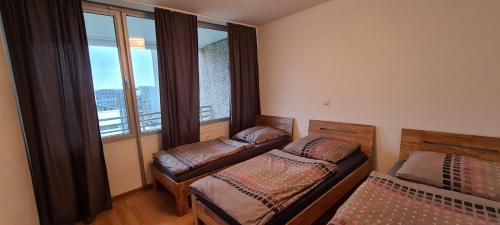 a bedroom with two beds and a large window at Equipment of Good And Night in Neuss