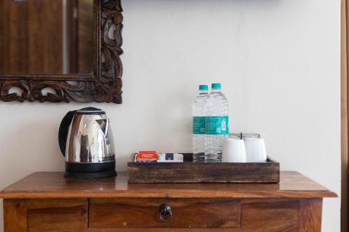 a table with two bottles of water and a blender at Yogved Hospitality & Resort in Rishīkesh