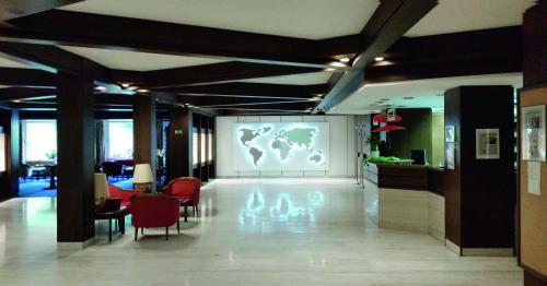 a large screen with a world on it in a lobby at RECHTMURG 27 in Baiersbronn