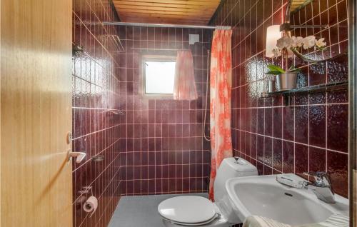 a bathroom with a toilet and a sink at Lovely Home In Grlev With Kitchen in Gørlev