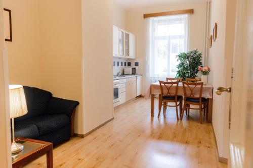 a living room with a table and a couch at Hotel Orion in Prague
