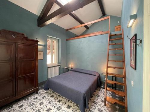 a bedroom with a bed and a wooden ladder at Beach Villa Fiorina in Ghiffa