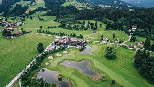 an aerial view of a golf course with a mansion at APART Resort Westendorf in Westendorf