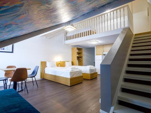 a room with a bed and a staircase and a bedroom at Central City Apartments in Oslo