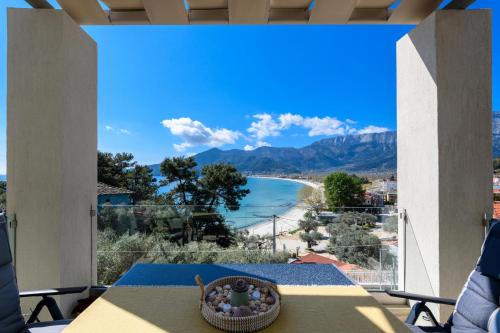 a view of a beach from the balcony of a house at Archetypo Luxury Living in Chrysi Ammoudia