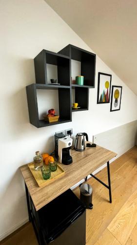 a kitchen with a wooden table with a coffee maker at Alfea Deluxe Loft & Rooms in Trento