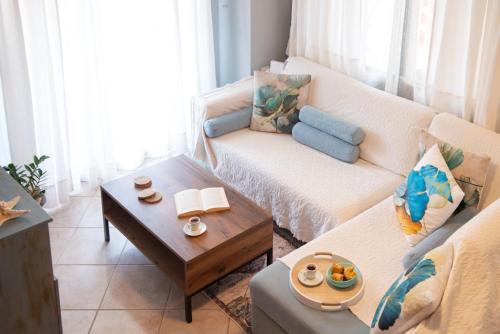 a living room with a couch and a coffee table at Stella's Beach House in Nikiti