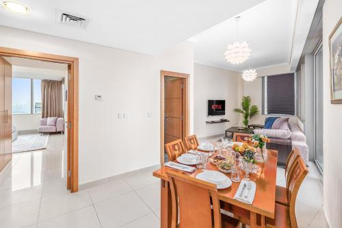 a dining room and living room with a table and chairs at Breathtaking sea-view condo in Dubai Marina - Palm Views! in Dubai