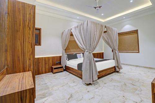 a bedroom with a bed with a canopy at Ratna Vilas Palace in Rajkot