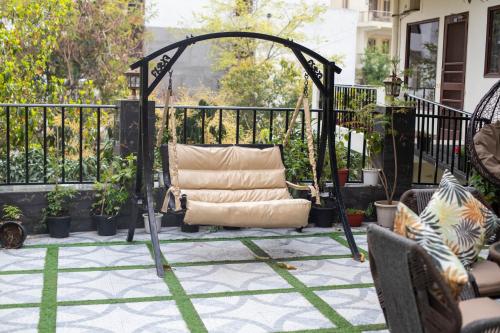 a chair on a patio with a gazebo at Yogved Hospitality & Resort in Rishīkesh