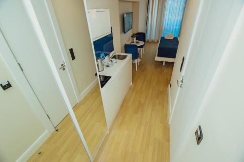 a bathroom with a mirror and a room with a table at Batumi River Source in Batumi
