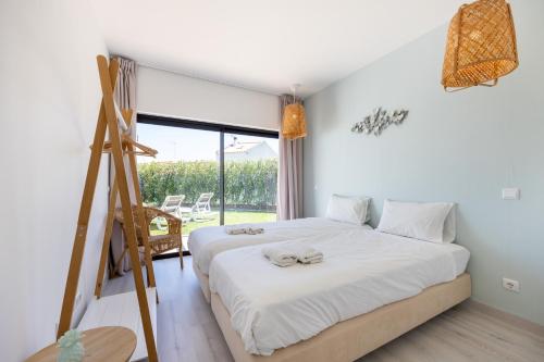 En eller flere senge i et værelse på Villa Front Loop