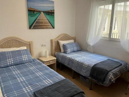 a bedroom with two beds and a window at Casa Pez Espada-A Murcia Holiday Rentals Property in Roldán