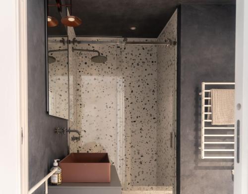 a bathroom with a shower with a glass door at Leoni 7 in Menaggio