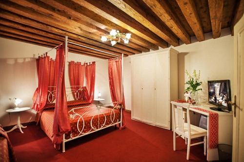 a room with a bed, a chair, and a lamp at Maison San Marco in Venice