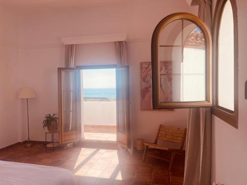 a bedroom with a large window with a view of the ocean at Sea view Villa La Alcaidesa in La Alcaidesa