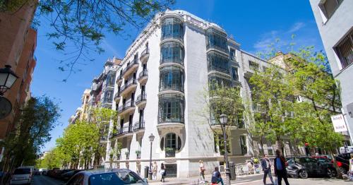 a tall white building on a city street at The Ultimate Home of Eurovision with Blas Cantó in Madrid