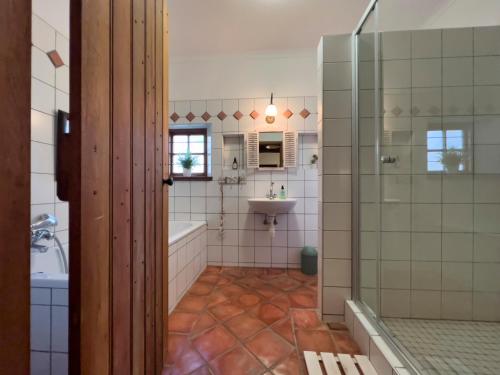 a bathroom with a shower and a tub and a sink at Mira Mar 8 in Swakopmund